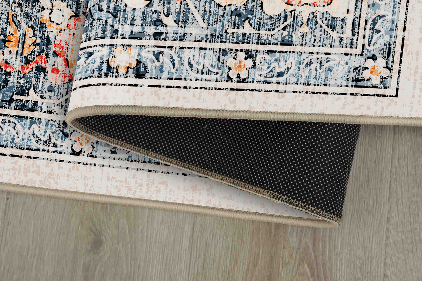 Sabrina Coral Medallion rug corner folded, showing the non-slip dot backing