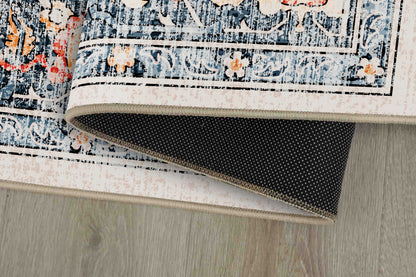 Sabrina Coral Medallion rug corner folded, showing the non-slip dot backing