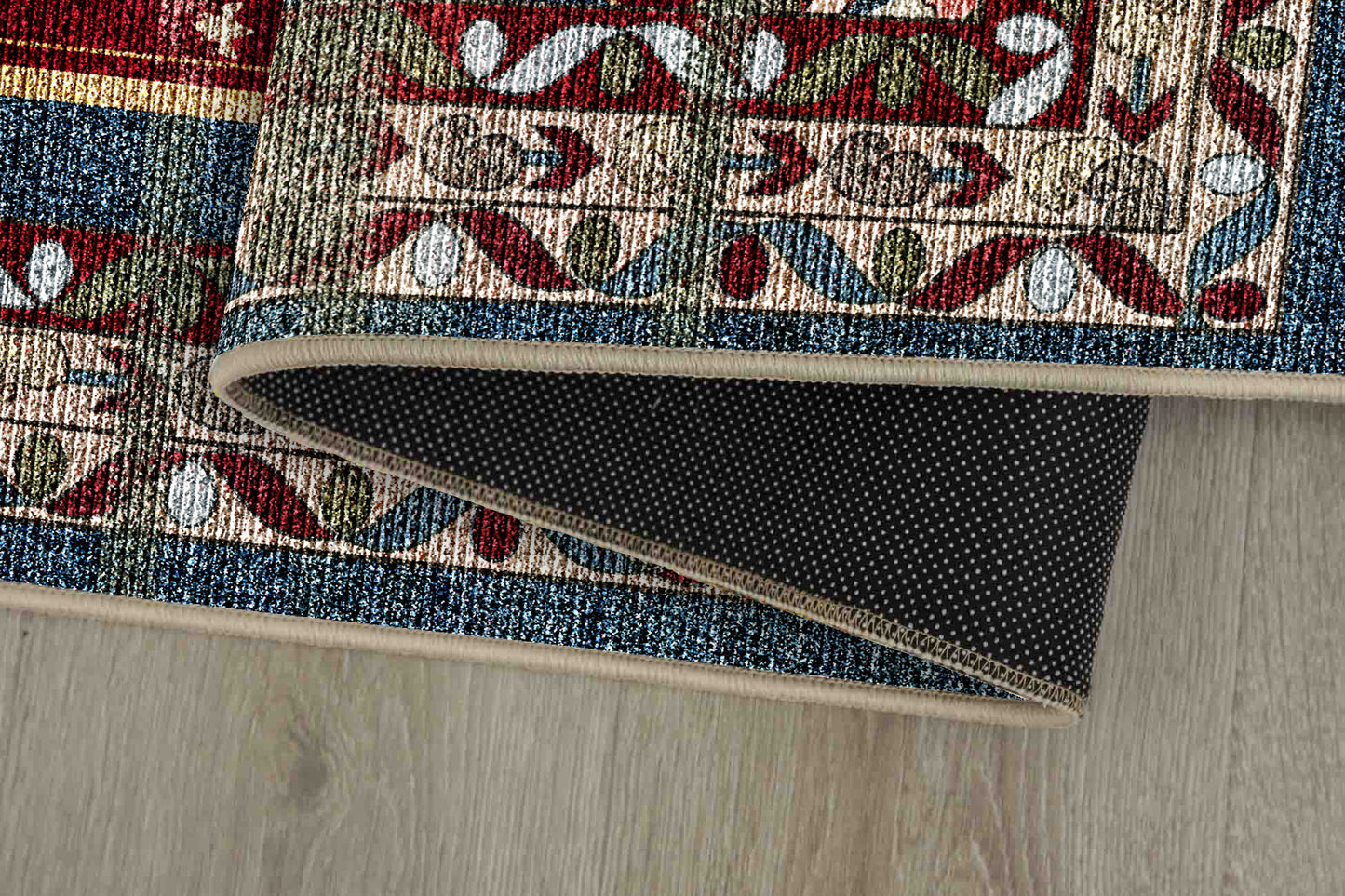 Sabrina Heritage Red rug corner folded, showing the non-slip dot backing