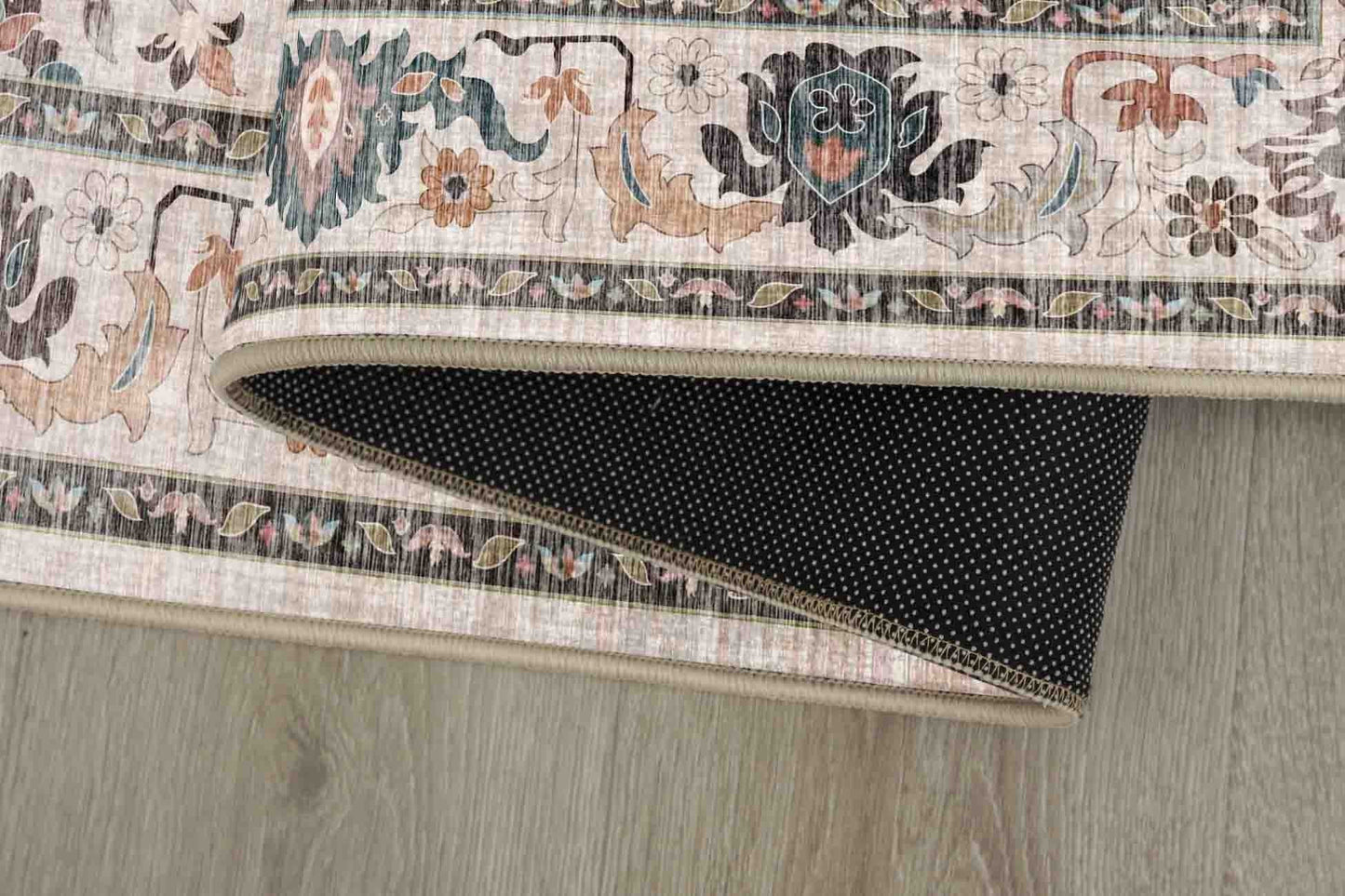 Sabrina Teal Trellis rug corner folded, showing the non-slip dot backing