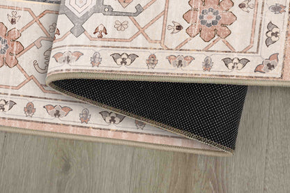 Sabrina Blush Medallion rug corner folded, showing the non-slip dot backing