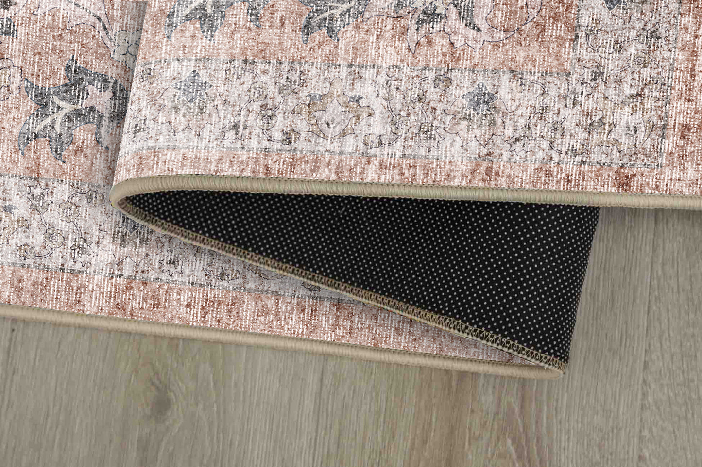 Sabrina Washed Rose rug corner folded, showing the non-slip dot backing