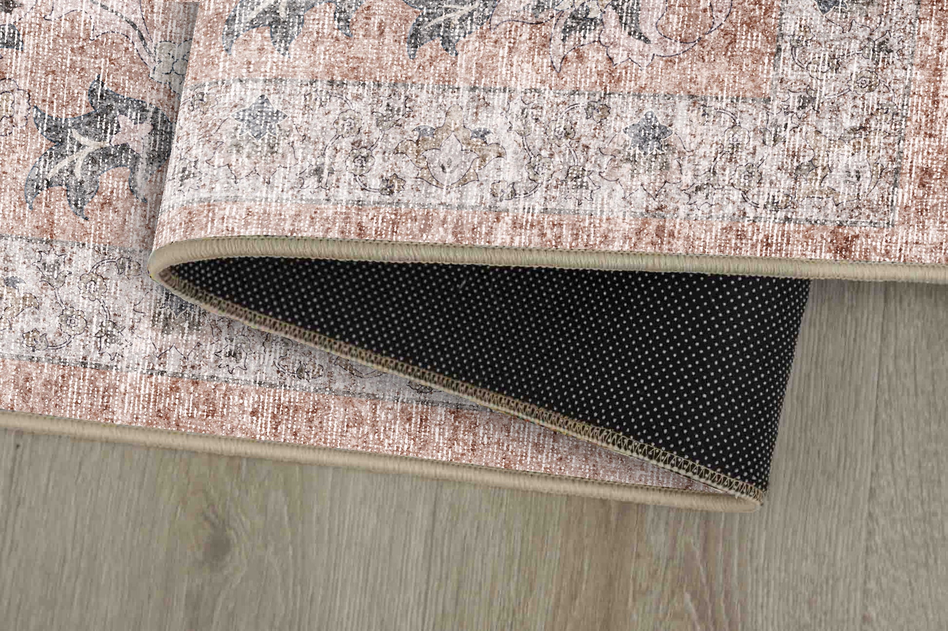 Sabrina Washed Rose rug corner folded, showing the non-slip dot backing