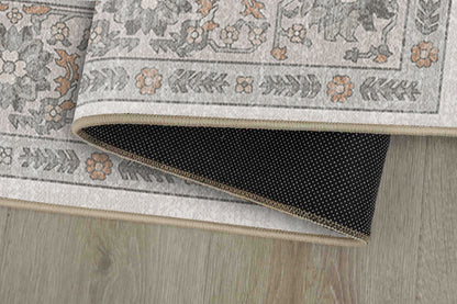 Sabrina Misty Grey rug corner folded, showing the non-slip dot backing