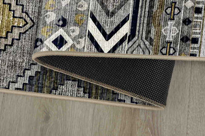 Tello Tribal Bands rug corner folded, showing the non-slip dot backing