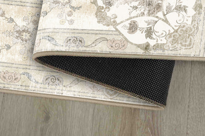 Tello Whisper Ivory rug corner folded, showing the non-slip dot backing
