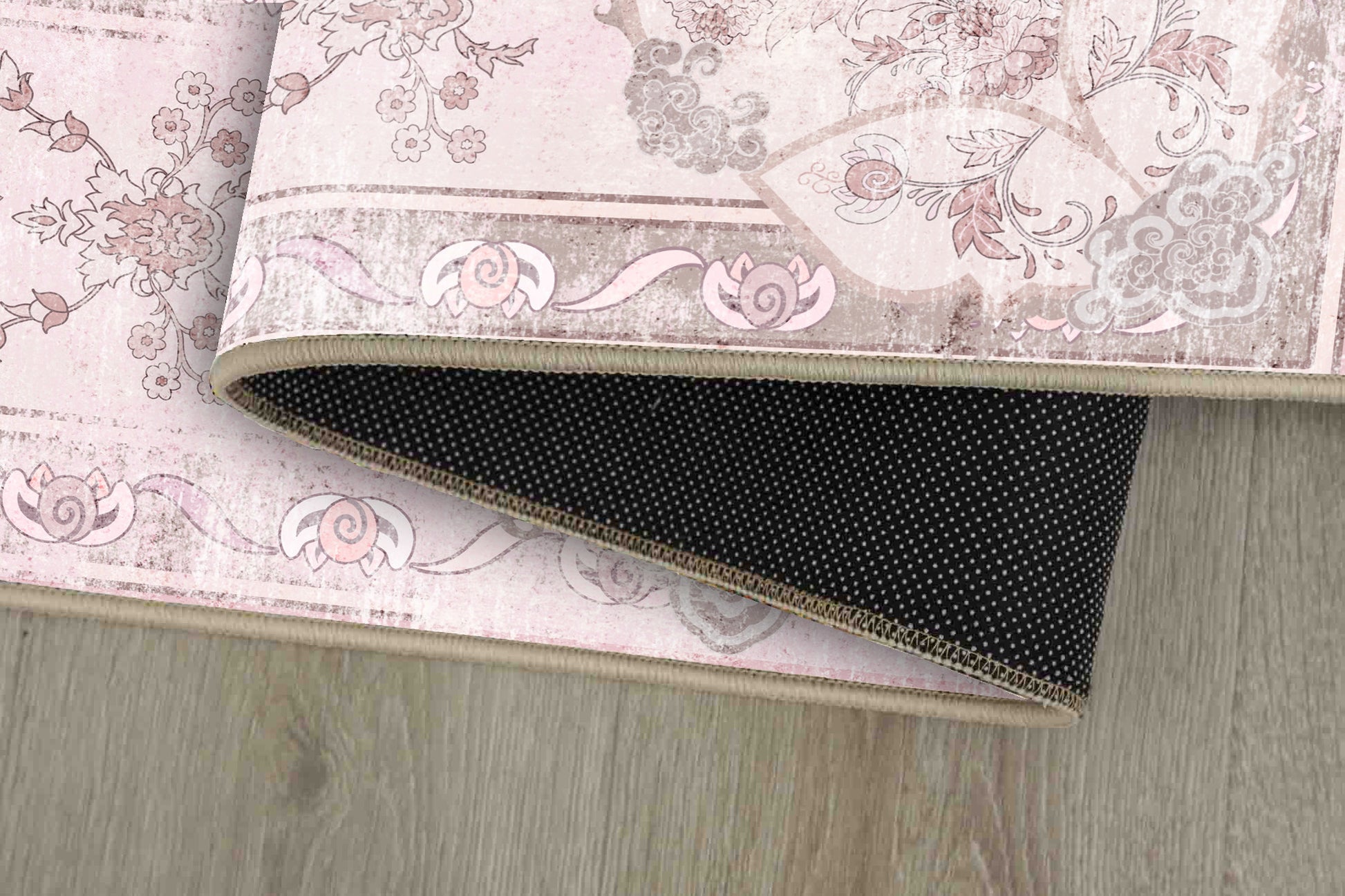 Tello Whisper Blush rug corner folded, showing the non-slip dot backing