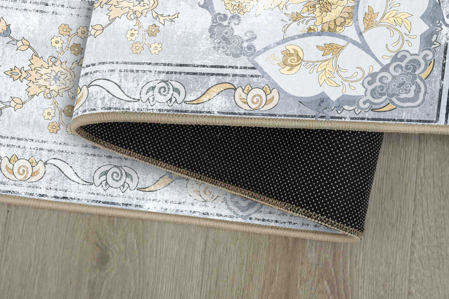 Tello Whisper Blue rug corner folded, showing the non-slip dot backing