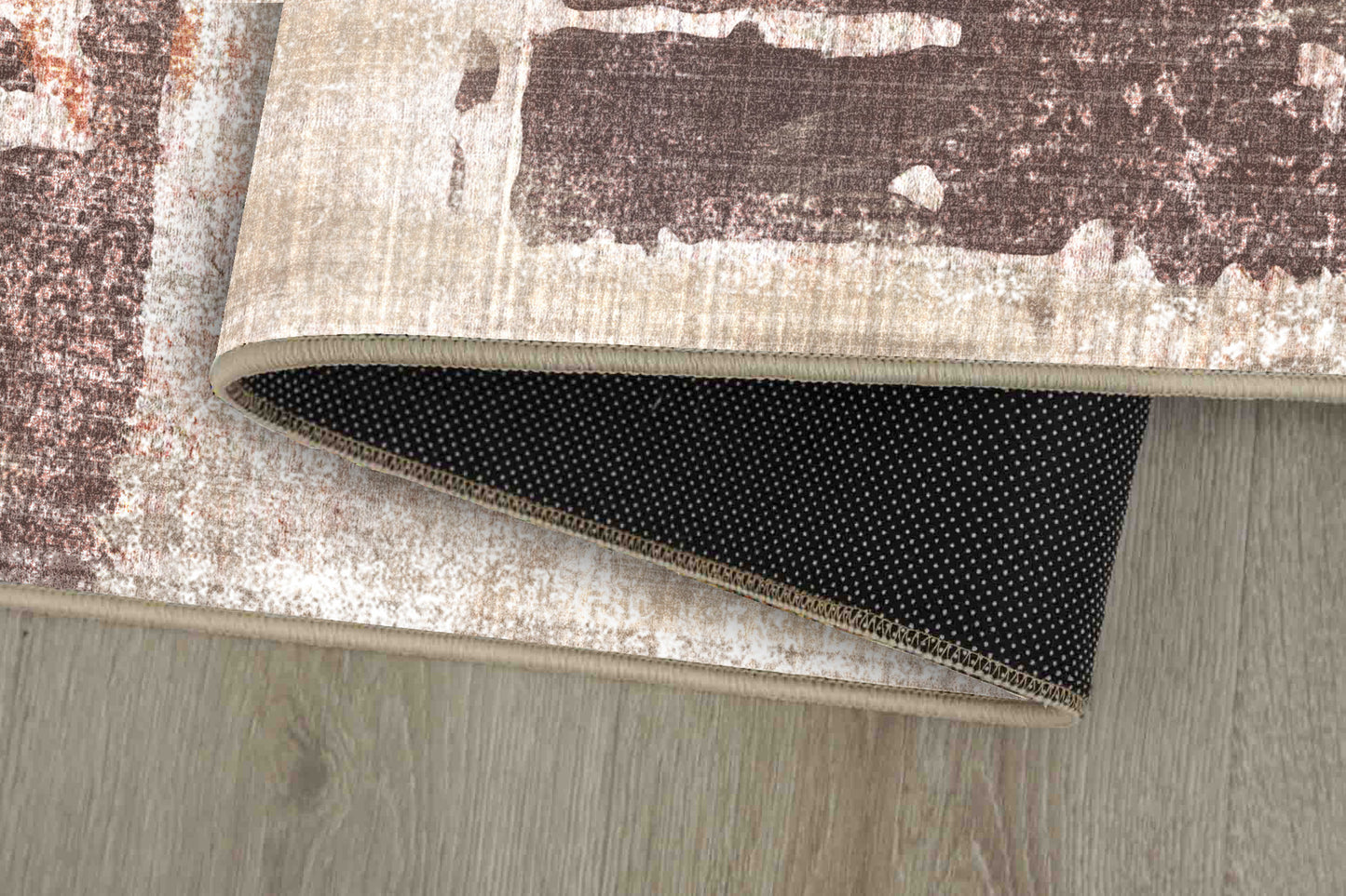 Torino Abstract Terracotta rug corner folded, showing the non-slip dot backing