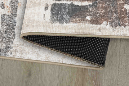 Torino Abstract Sage rug corner folded, showing the non-slip dot backing