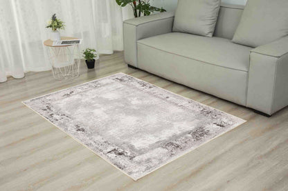 Torino Stone Border rug in a living room